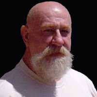 Simon DeVille Bald man with bushy white mustache and goatee